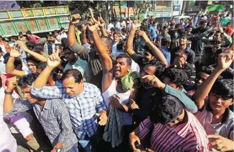  ?? AP ?? Supporters of Bangladesh’s main opposition BNP shout slogans during a 48- hour nationwide strike in Dhaka yesterday. Activists
■ blocked roads, railways and waterways nationwide to protest government plans to hold a general election on January 5.