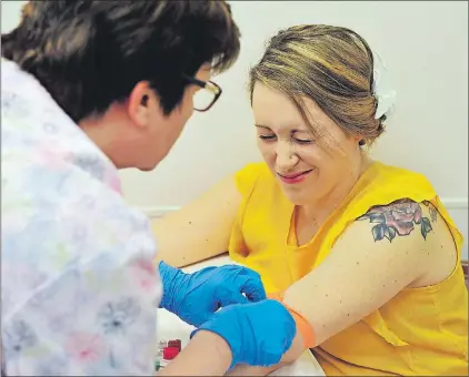  ?? AP PHOTO ?? Nurse Kim Gates draws blood from Heidi Wyandt, 27, at the Altoona Center for Clinical Research in Altoona, Pa.