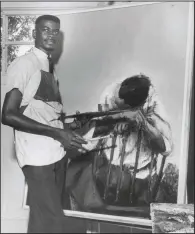  ?? (Courtesy Henri Linton) ?? Henri Linton with his painting Alone, circa 1965. Linton won the Award for Best Portrait or Figure in Oil in the 1968 Atlanta University 27th Annual Exhibition of Paintings, Sculptures and Prints by Negro Artists.