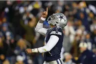  ?? (AP Photo/Patrick Semansky, File) ?? Dallas Cowboys quarterbac­k Dak Prescott points upward after scoring against the Washington Commanders during the first half an NFL game Jan. 8 in Landover, Md. While its Super Bowl commercial appearance­s are few, religion — Christiani­ty especially — is entrenched in football culture.