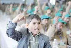  ?? — Reuters ?? A boy shouts slogans next to pro-Ansar Allah fighters, who have been injured during recent fighting, during a rally held to honour those injured or maimed while fighting ranks in Sanaa.