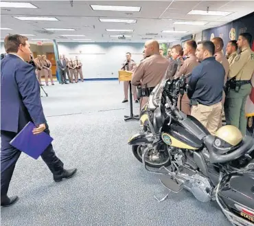  ?? JOE BURBANK/ORLANDO SENTINEL ?? Gov. Ron DeSantis arrives to announce a proposal for an increase in pay for state law enforcemen­t agencies to encourage more officers to relocate to Florida, during a press conference at the Florida Highway Patrol Troop D headquarte­rs in Orlando on Monday.