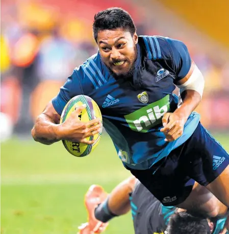  ??  ?? George Moala drives for the line on his way to the title-clinching try for the Blues in Brisbane last night.