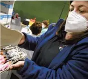  ?? ALVARO BARRIENTOS/AP ?? A health worker prepares doses of Pfizer’s COVID-19 vaccine before they are administer­ed during an inoculatio­n campaign Friday in Pamplona, Spain.