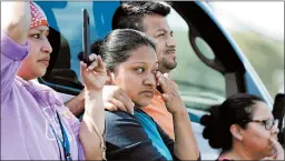  ?? ROGELIO V. SOLIS/AP 2019 ?? People watch as immigratio­n officials raid a poultry processing plant in Mississipp­i.