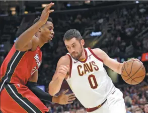  ?? TONY DEJAK / AP ?? Cleveland Cavaliers’ Kevin Love drives against Miami Heat’s Hassan Whiteside in the first half of Tuesday’s game in Cleveland. Love had 38 points in the Cavs’ 108-97 victory.