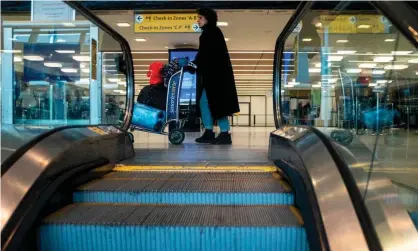  ??  ?? People walk in the departure hall of terminal 7 at JFK airport in New York City on 15 March. Photograph: Johannes Eisele/AFP via Getty Images