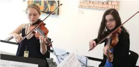  ??  ?? Hot Springs Music Festival string quartet violinists Lara Madden, left, of River Forest, Ill. and Laura Stiener of Las Cruces, N.M. rehearse with others at the Fine Arts Center of Hot Springs in 2016.