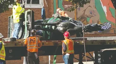  ?? TOM BLACKWELL/NATIONAL POST ?? Workers cart away a statue of Theodore Roosevelt after protesters pulled it down in a Portland, Ore. The city, as the centre of America's anti-racism movement, became a focus of President Donald Trump's re-election campaign.