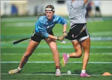  ?? AP ?? Ashlea Klam pulls a flag from a teammate during a training session for Keiser University’s flag football team in Florida last year.