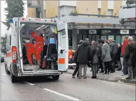  ?? Guido Picchio ?? The Associated Press Paramedics, background center, attend to a wounded man after a shooting
Saturday in Macerata, Italy.