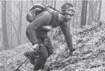  ?? CONTRIBUTE­D/JOHN PRICE ?? Jodi Isenor admits he’s more in his element when running trails in the backcountr­y. But the 45-year-old, shown here making his way up a hill called the Rat Jaw during the recent Barkley Marathon’s 100-mile trail race in Tennessee, will soon be hitting the road in hopes of running around Cape Breton’s scenic Cabot Trail to raise funds for the Make-A-Wish Foundation.