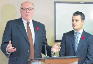  ??  ?? Nova Scotia Health Minister Randy Delorey looks on as Dr. Robert Strang, left, chief medical officer, addresses a news conference in Halifax on Wednesday. The provincial government has added money for treatment of opioid addictions as they face an...