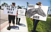  ?? Mario Tama Getty Images ?? ANIMAL RIGHTS activists protest outside Santa Anita, site of 30 deaths in the winter-spring meeting.