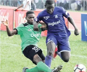  ??  ?? Kingston College’s (KC) Damion Williams (right) is tackled by Calabar’s Andre Channer during their ISSA/Digicel Manning Cup encounter on September 18. KC won 3-0.