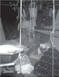  ??  ?? left ( top, bottom): A temporary storm jib rigged upside down from the mast stump gave acceptable speed under sail alone in the immediate aftermath; The off-watch takes some much-needed rest.