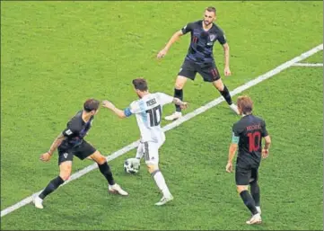  ?? REUTERS ?? Lionel Messi was hardly allowed any space by the combative Croatians during their group stage match ■ in Nizhny Novgorod on Thursday. The 30 win helped Croatia qualify for the round of 16.