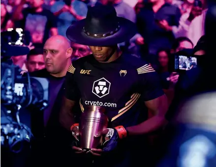  ?? GETTY IMAGES ?? Israel Adesanya prepares to enter the octagon carrying an urn for his middleweig­ht title bout against Jared Cannonier during UFC 276 at T-Mobile Arena in Las Vega on Sunday.