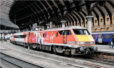  ?? RON COVER. ?? Virgin Trains East Coast 91106 stands at York on March 24, with the 1100 London King’s Cross-Edinburgh. It is carrying an advertisin­g livery highlighti­ng the Great Exhibition of the North event that begins in late June. Politician­s north of the border,...