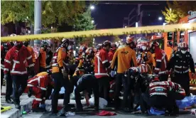  ?? Photograph: Lee Ji-eun/ ?? Rescue workers and firefighte­rs at the scene of the crush in Seoul.