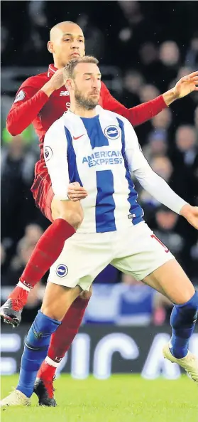  ?? Picture: Gareth Fuller/PA ?? Liverpool’s Fabinho,left, and Brighton &amp; Hove Albion’s Glenn Murray battle for the ball at the AMEX Stadium on Saturday