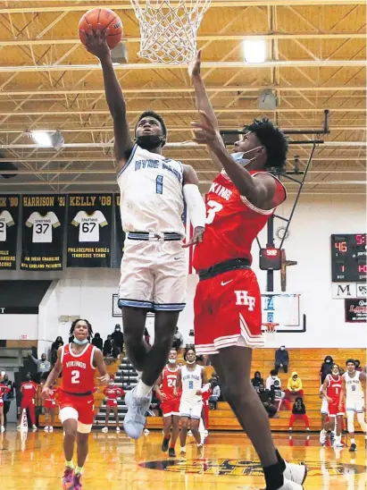  ?? ALLEN CUNNINGHAM/SUN-TIMES ?? Hyde Park’s Davontae Hall floats down the lane for a basket Monday against Homewood-Flossmoor.