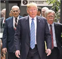  ?? SEAN KILPATRICK/THE CANADIAN PRESS VIA AP ?? President Donald Trump leaves the G-7 Leaders Summit in La Malbaie, Quebec, on Saturday, with White House chief of staff John Kelly, left, and national security adviser John Bolton.