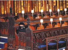  ?? AFP ?? Queen Elizabeth II takes her seat for the funeral of the Duke of Edinburgh in St George’s Chapel, Windsor Castle.