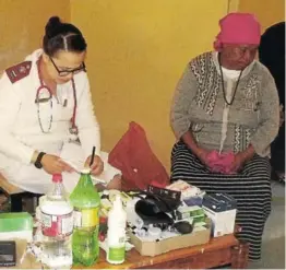  ?? Picture: DESMOND COETZEE ?? HEALTH INITIATIVE: Breidbach Clinic profession­al nurse Brazie Genade, left, does a health check on Nosisi Jacobs during a clinic drive to Acorn Village on Monday