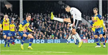  ??  ?? Full stretch: Fulham striker Aleksandar Mitrovic scores his side’s decisive third goal to clinch a much-needed victory