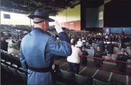  ??  ?? Police salute during the national anthem at the funeral of State Police Sgt. Brian Mohl, who was swept away in floodwater­s in Woodbury from the remnants of Hurricane Ida, at the Xfinity Theatre in Hartford on Thursday.