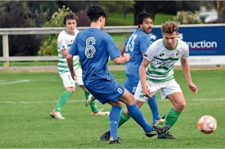  ?? RACHEL FINDON ?? Palmerston North Marist’s Jake Erskine navigates a Massey tackler in his side’s 1-0 victory on Saturday.