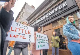  ?? MICHAEL BRYANT/THE PHILADELPH­IA INQUIRER ?? Protesters gather Sunday outside the Starbucks shop in Philadelph­ia where two black men were arrested after staff told police they were trespassin­g.