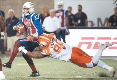  ?? CP PHOTO ?? Davon Coleman of the B.C. Lions dives to take down Montreal Alouettes quarterbac­k Antonio Pipkin during the second half of Friday night’s CFL game in Montreal.