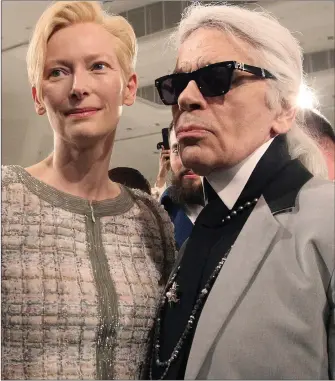  ??  ?? „ Karl Lagerfeld, here with actress Tilda Swinton, worked with a small team to create his collection­s.