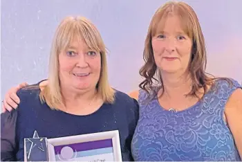  ?? ?? HONOURED: Lorna Menzies, left, with manager Morag Shea, who nominated her.