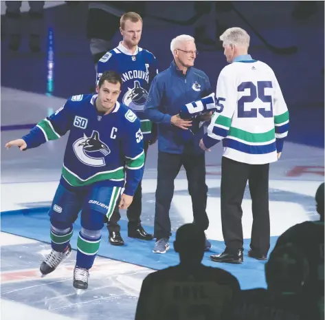  ??  ?? The Canucks’ Bo Horvat skates proudly in his new jersey Wednesday, after being named captain during a pre-game ceremony at Rogers Arena.