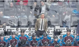  ??  ?? Avalanche coach Jared Bednar sports a “camo” jacket Wednesday night during a 3-2 victory against the Buffalo Sabres at the Pepsi Center.