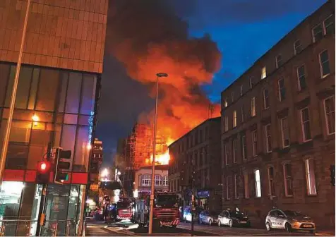  ?? AP ?? Flames and smoke rise from the Glasgow School of Art’s Mackintosh Building in London, early yesterday. A large blaze ripped through the building at the Glasgow School of Art late on Friday, the second time in four years that fire has damaged the famed Scottish school. No casualties were reported.
