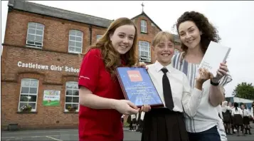  ??  ?? Castletown Girls School accepting their award and classroom pack of tablets from Lisa McGrenra, Road Safety Promotion Officer, RSA