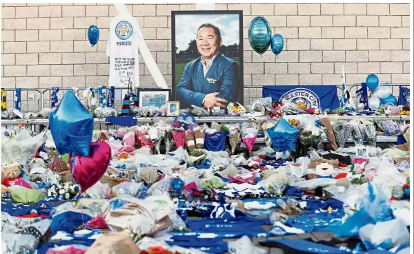  ?? — Reuters ?? You will be missed: Leicester fans paying tributes to owner Vichai Srivaddhan­aprabha and four other people who died in the helicopter crash outside the King Power Stadium on Tuesday.