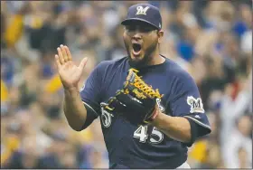  ?? AP/MORRY GASH ?? Milwaukee starting pitcher Jhoulys Chacin reacts Friday after Colorado’s Trevor Story strikes out in Milwaukee.