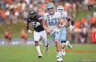  ?? SCOTT TAETSCH/USA TODAY SPORTS ?? North Carolina quarterbac­k Drake Maye shows off his running skills against Virginia during the first half at Scott Stadium.