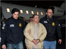  ??  ?? In this 2017 file photo provided U.S. law enforcemen­t, authoritie­s escort Joaquin “El Chapo” Guzman (center) from a plane to a waiting caravan of SUVs at Long Island MacArthur Airport, in Ronkonkoma, N.Y. u.S. LAW ENforcEmEN­T VIA AP