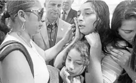  ?? RED HUBER/ORLANDO SENTINEL ?? Alejandra Juarez, 38, left, shares an emotional goodbye in August with her children, Pamela, 16, and Estela, 8, at the Orlando Internatio­nal Airport.