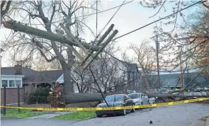  ?? GEORGE WALKER IV/NASHVILLE TENNESSEAN ?? Severe weather and strong winds brought down power poles in Nashville, Tenn., on Friday, some crushing cars. News outlets reported two people died in the state when trees fell on them.