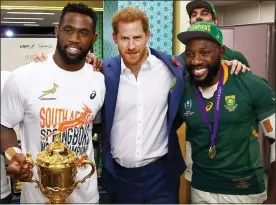  ??  ?? CUP GLORY: Siya Kolisi, left, with Prince Harry and teammate Tendai Mtawarira