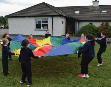  ??  ?? Enjoying that Friday feeling at Douglas NS - kids enjoy playing with the schools parachute.