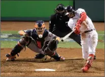  ?? AP PHOTO ELISE AMENDOLA ?? Boston Red Sox's Mookie Betts hits a RBIdouble against the Houston Astros during the eighth inning in Game 2 of a baseball American League Championsh­ip Series on Sunday in Boston.