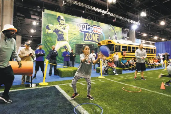  ?? RALPH FRESO / ASSOCIATED PRESS ?? Visitors experience the PLAY 60 area at the NFL Experience during last year’s event at the Phoenix Convention Center. The fitness and nutrition program encourages communitie­s to think about where children can play, how they play and why they play.